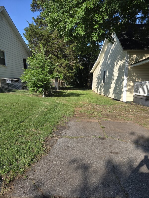 Side yard freshly mowed and edged between two houses